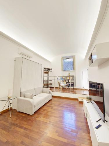 a living room with a white couch and a table at Like at Home Trastevere in Rome
