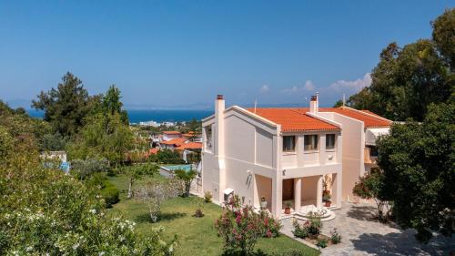 a large white house with a red roof at Horizon Villa-Private Pool-7 Bedroom-Gym-Sea View in Psalidi
