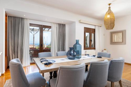 a dining room with a table and chairs at Horizon Villa-Private Pool-7 Bedroom-Gym-Sea View in Psalidi
