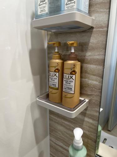 two bottles ofodorizers sit on a shelf in a refrigerator at 貸し切りゲストハウスsai2nd in Yasugi