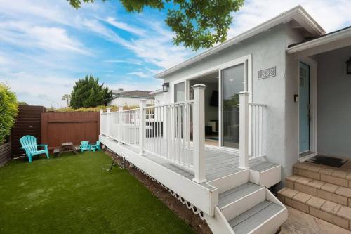 a house with a white deck and a yard at Beach House In The Heart Of PB in San Diego