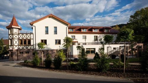 a large white building with a clock tower at Hotel Rebstock in Baden-Baden