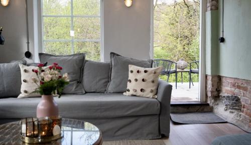 a living room with a couch and a glass table at Forest house in Ljungskile