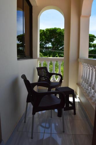 two chairs and a table in front of a window at HOTEL TIFFANY in Mombasa