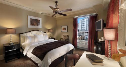 a bedroom with a large bed and a window at Kensington Park Hotel in San Francisco