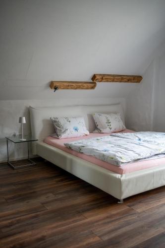 a bed with two pillows on it in a room at Wallys Hüsli im Schwarzwald in Ühlingen-Birkendorf