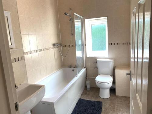 a bathroom with a tub and a toilet and a sink at Doctors, Nurses, Families and contractors welcome in Huntingdon