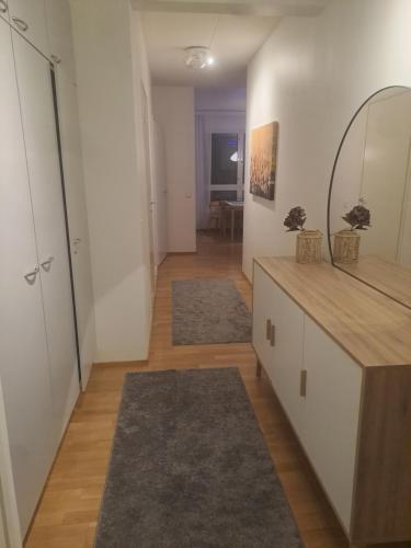 a living room with a counter and a mirror at Bright apartment, airport 3km, private parking, sauna in Vantaa