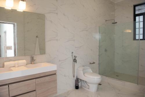 a bathroom with a sink and a shower and a toilet at CASA BIANCA Bella Vista in Panama City