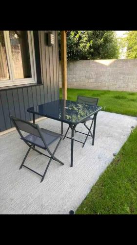 a glass table and a chair on a patio at Centre Quimper, animaux déclarés acceptés in Quimper