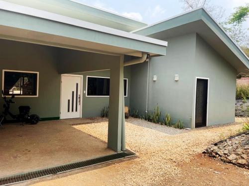 a small house with a blue roof at Casa Mari Black Stallion in Tamarindo