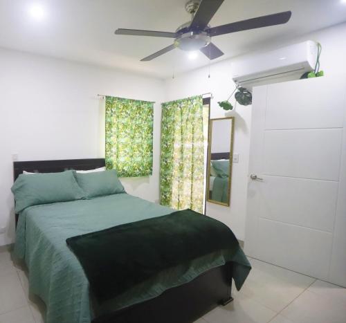 a bedroom with a bed and a ceiling fan at Casa Mari Black Stallion in Tamarindo