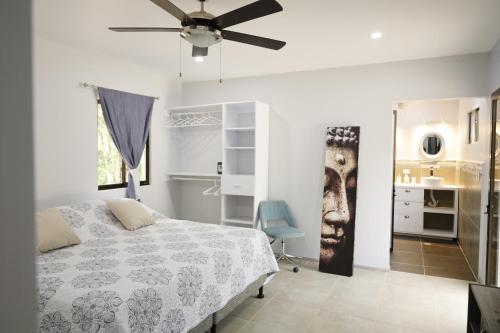 a bedroom with a bed and a ceiling fan at Casa Mari Black Stallion in Tamarindo