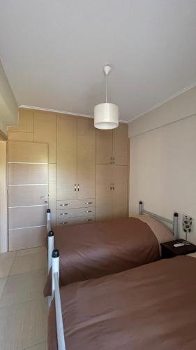 a bedroom with two beds and a light at Sea House in Chiliadou