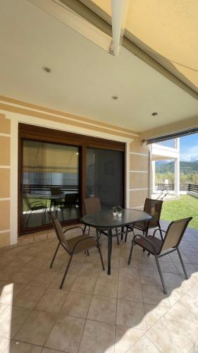 a patio with a black table and chairs at Sea House in Chiliadou