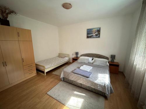 a small bedroom with two beds and a cabinet at Apartmani Grgić in Trogir