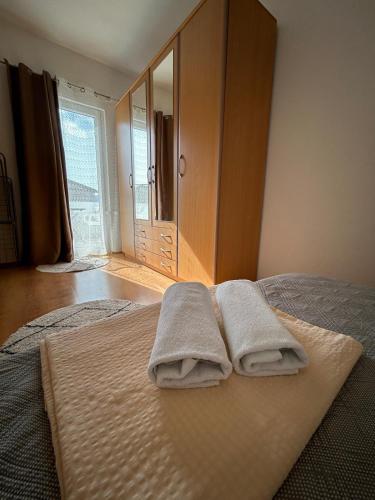 a bedroom with two towels sitting on a bed at Apartmani Grgić in Trogir