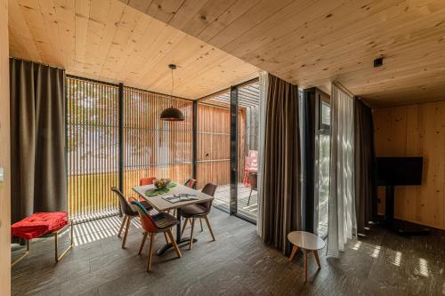 a dining room with a table and chairs on a balcony at Hotel Le Prese in Poschiavo