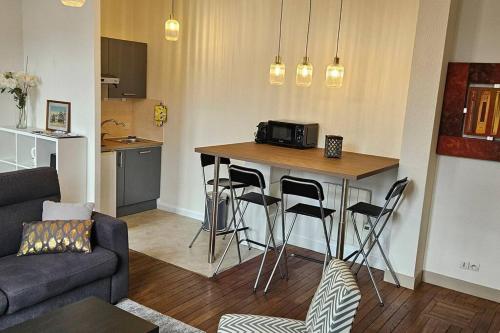 - un salon avec une cuisine dotée d'un bar avec tabourets dans l'établissement Un séjour à Tours centre place des Halles, à Tours