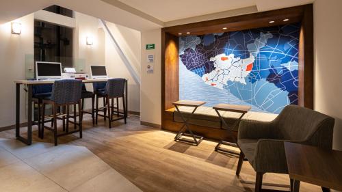 a lobby with a map of the world on the wall at Holiday Inn Express Morelia Centro Historico in Morelia