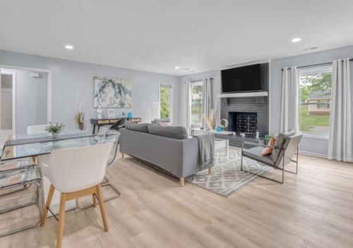 a living room with a couch and a fireplace at Stylish Home Near Uptown, UNC, and More! in Charlotte
