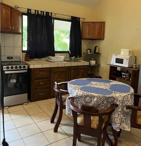 a kitchen with a table with a tablecloth on it at Tucan Studio Ocotal in Coco