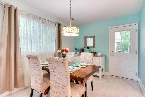 a dining room with a wooden table and chairs at Cozy Goose Creek Escape with Patio and Grill in Goose Creek