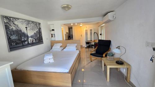 a bedroom with a bed and a chair and a table at BougainvillaStudio in Cesme