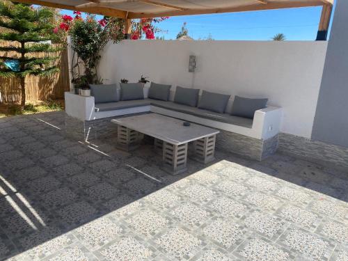 a couch and a coffee table on a patio at Dar Zina in Al Maqārisah