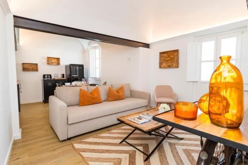a living room with a couch and a table at CICIOSO flats Salvador in Évora