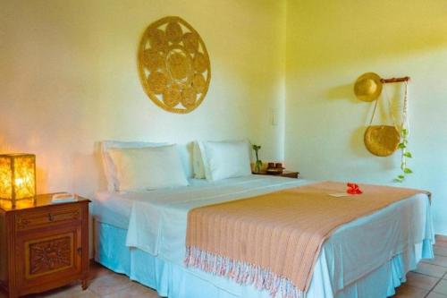 Un pat sau paturi într-o cameră la Pousada Sossego