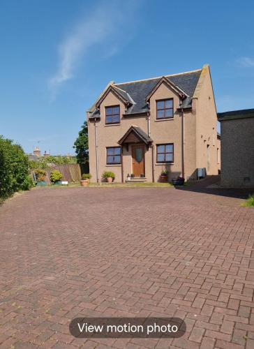 a brick driveway in front of a house at Room on the River in Cruden Bay