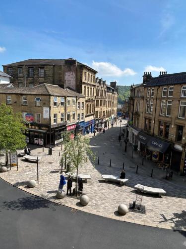 a city street with buildings and a plaza with benches at Crown Street Aparthotel in Halifax