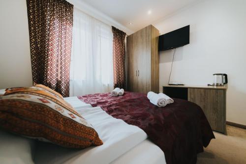 a hotel room with a bed with towels on it at Old Town Residence Rooms in Sarajevo
