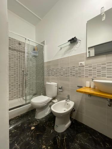 a bathroom with two toilets and a sink at Le Gorgoni b&b in Syracuse