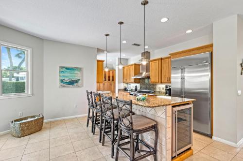 a kitchen with a island with bar stools at The Sun Dial - 827 in Siesta Key