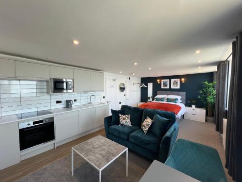 a kitchen and a living room with a couch and a bed at The Marlborough Sea View Holiday Apartments in Scarborough