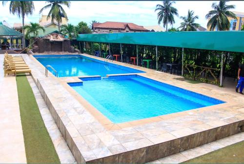 a large swimming pool next to a building at St. Regis Hotel & Resort - Benin City in Benin City