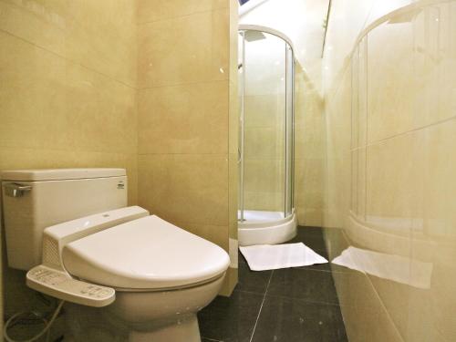 a small bathroom with a toilet and a shower at The Great Wall Box House - Beijing in Miyun