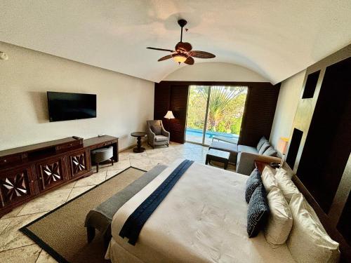 a bedroom with a large bed and a living room at Hotel Hacienda San Pancho in San Francisco