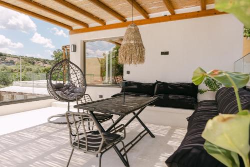 a living room with a couch and a table at Villa Aldea - Luxury Boho Style in Melidhónion