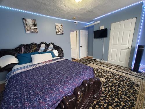 a bedroom with a large bed with blue walls at CHRIS LUXURY HOME in Baltimore