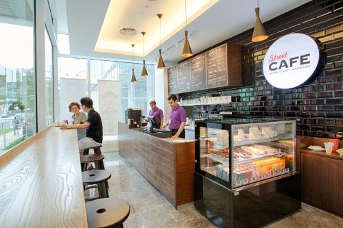 a group of people standing at a counter in a bakery at WP Hotel in Kuala Lumpur