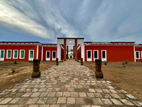 a red building with a brick walkway in front of it at Hotel Hacienda San Pancho in San Francisco