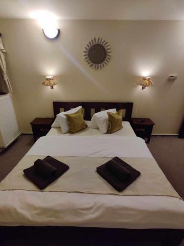 a bedroom with a large white bed with two towels on it at Hájenka Knížecí Pláně in Borová Lada