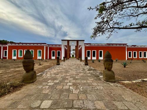 a building with two head statues in front of it at Hotel Hacienda San Pancho in San Francisco