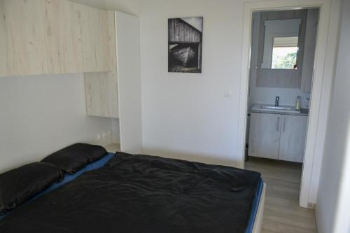 a bedroom with a bed and a sink in it at Holiday Homes Ahil 7&8 in Pakoštane