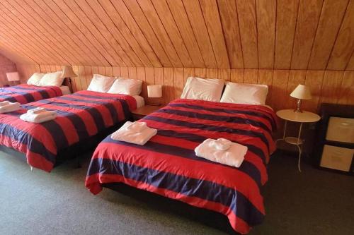 a room with two beds with towels on them at Flyers' Landing in Jacksboro