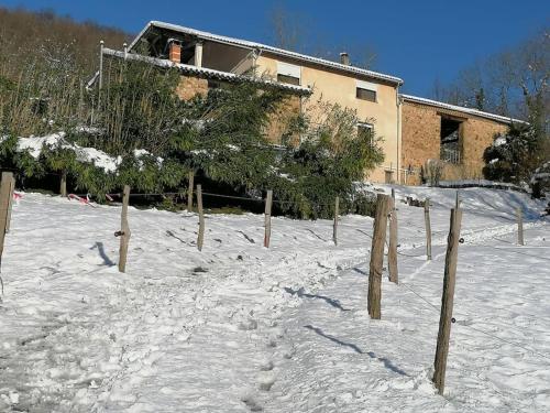 a fence in the snow in front of a house at Les Merens in Baulou