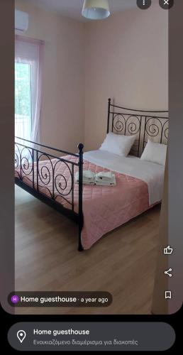 a bedroom with a bed with a black bed frame at home_nafplio in Nafplio